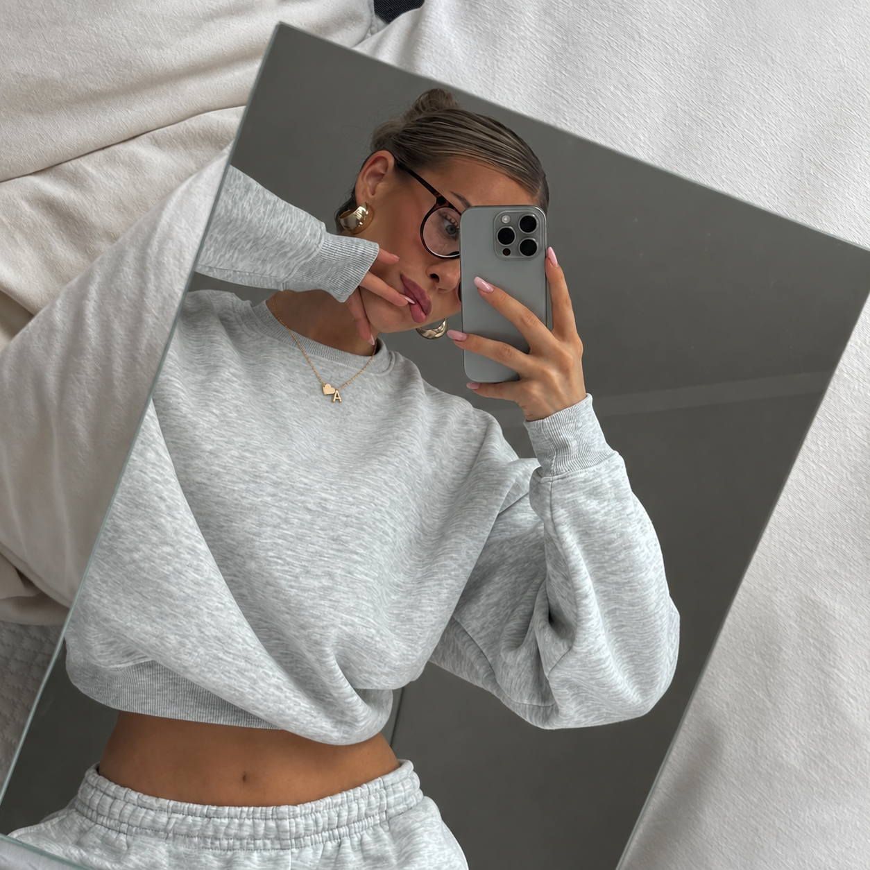 Heart and initial necklace with a light gray crewneck and matching casual outfit