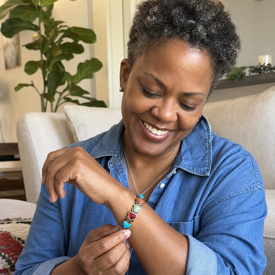 Black woman adjusting the Aura bracelet at home