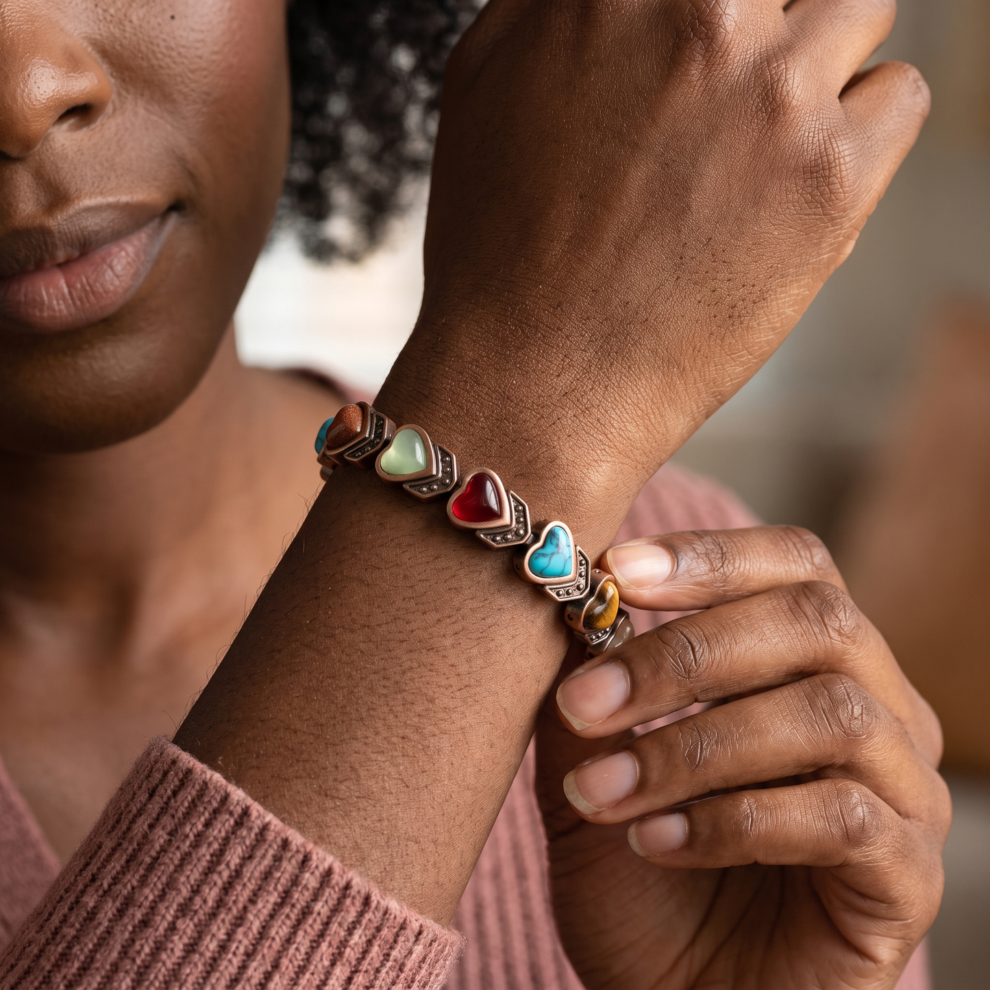 Black woman wearing the Aura bracelet in a close heart-stone view