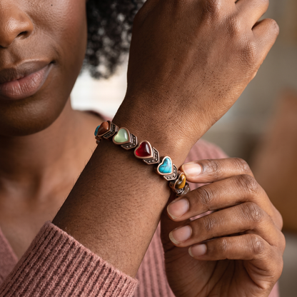 Black woman wearing the Aura bracelet in a close heart-stone view