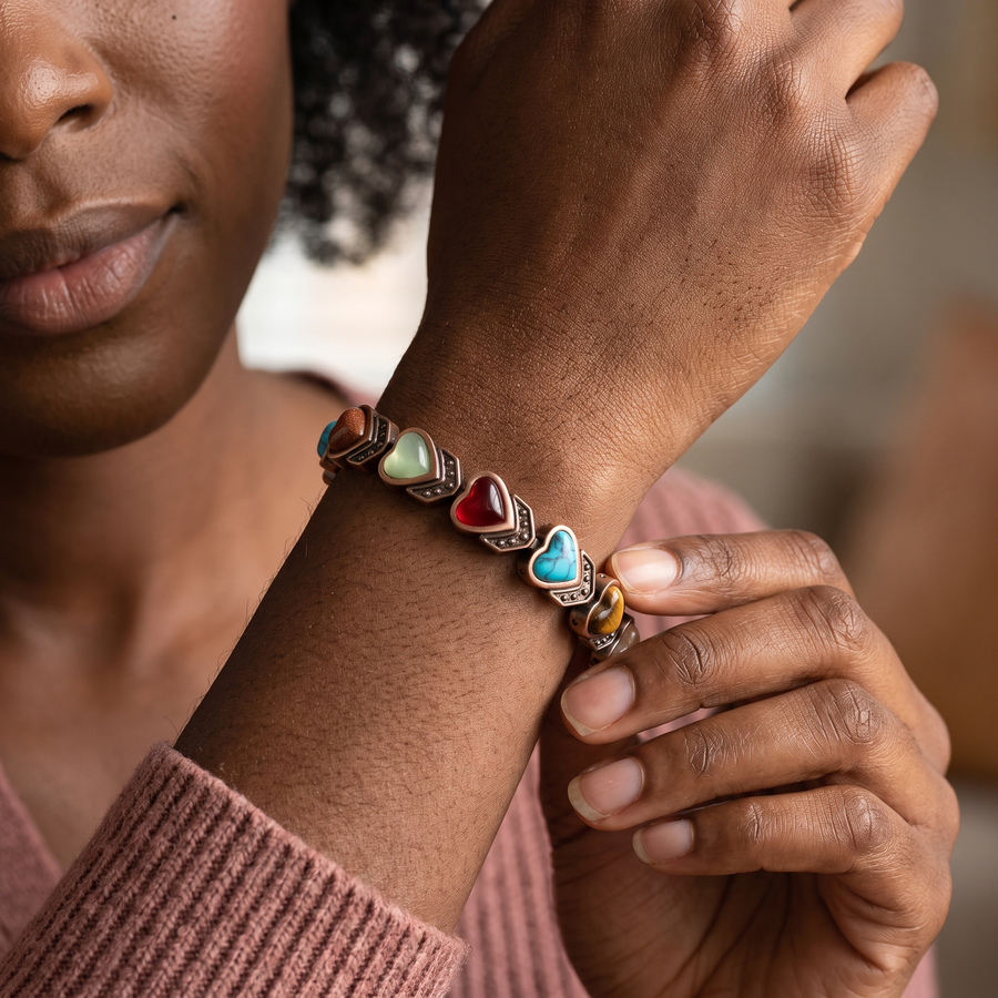 Black woman wearing the Aura bracelet in a close heart-stone view