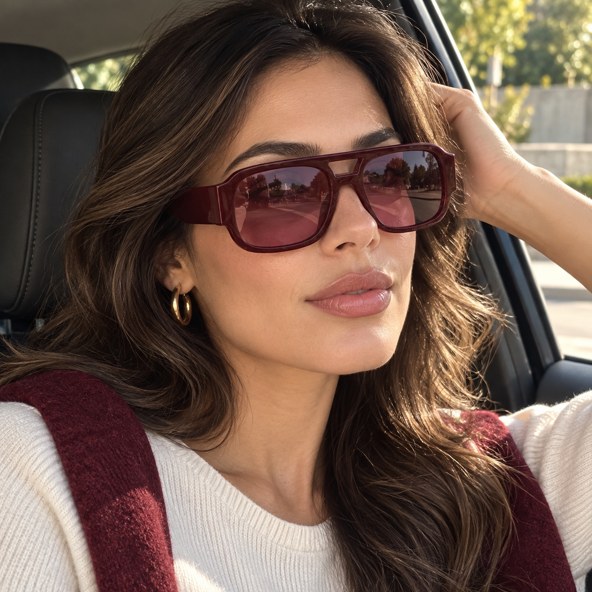 Woman wearing Cevani Chunky Aviator Sunglasses in Wine in a close car-side styling view