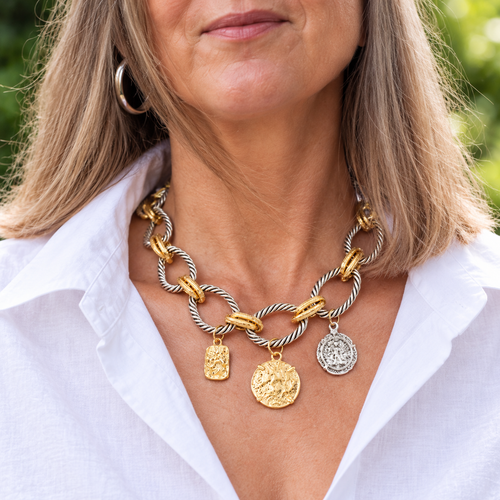Close view of mixed-tone necklace worn with an open white collar