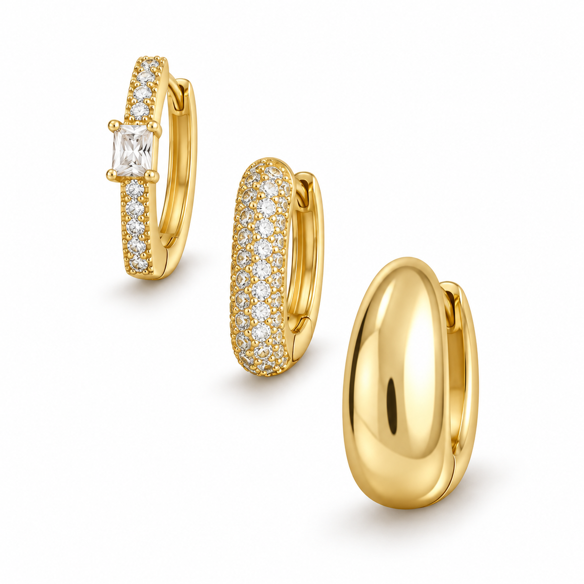 Gold Tone three-piece chunky hoop earring set on white