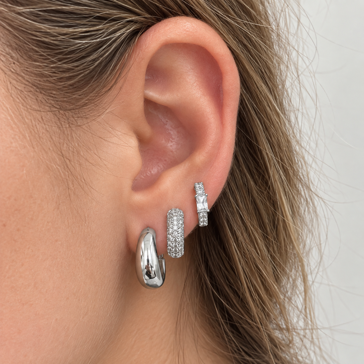 Close on-ear view of the Silver Tone three-piece earring stack