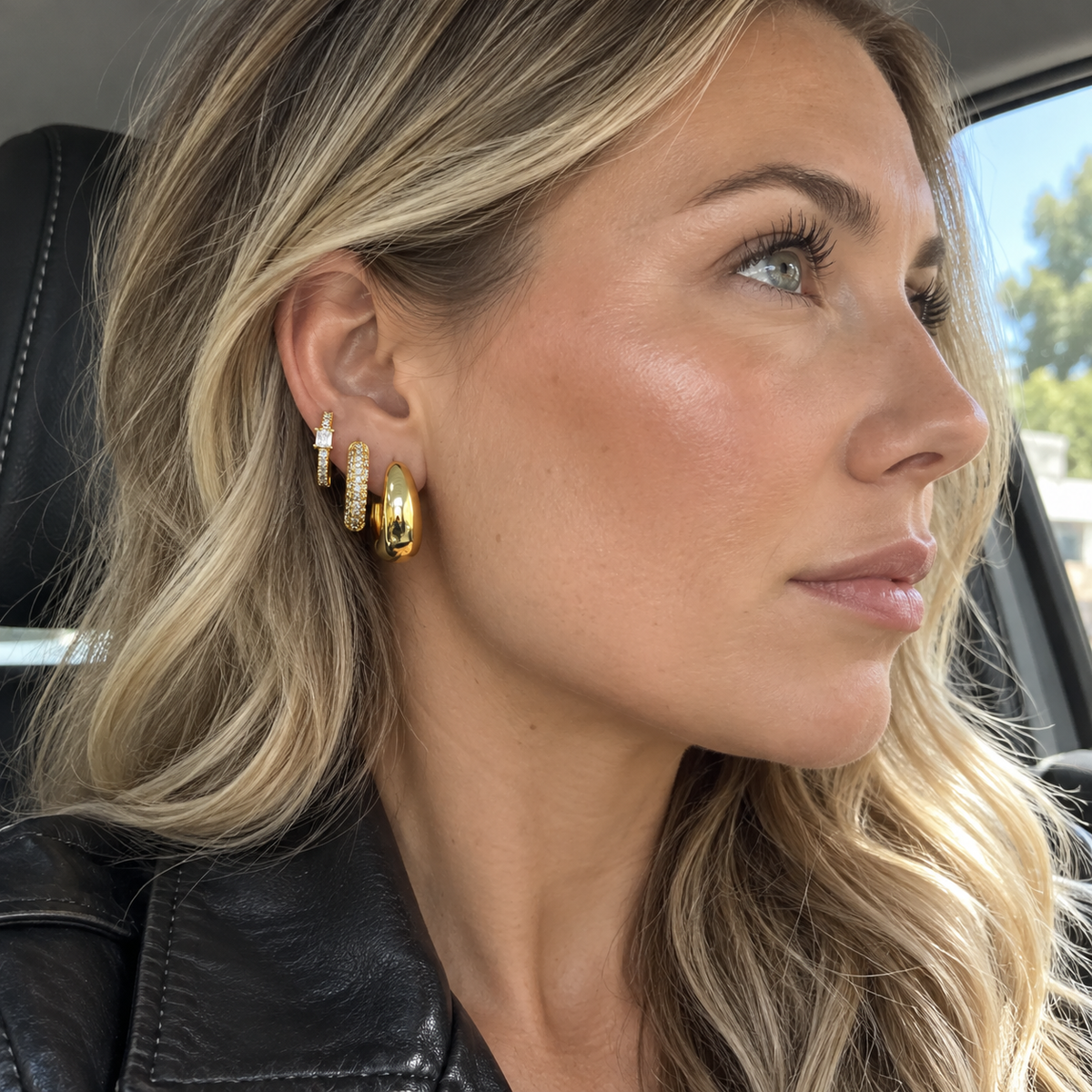 Blonde woman wearing the Gold Tone earring stack in daylight