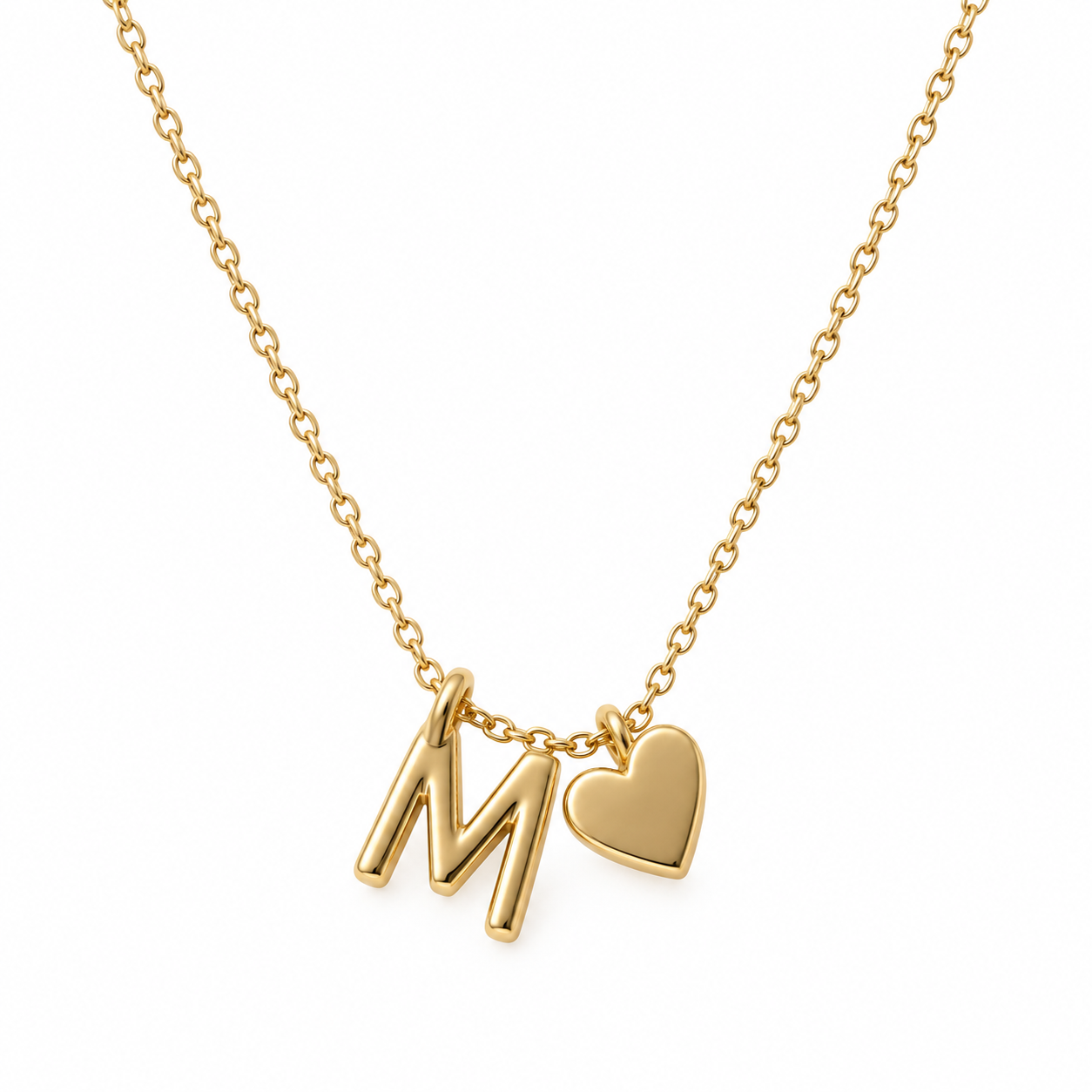Close view of an M initial beside a separate smooth heart charm