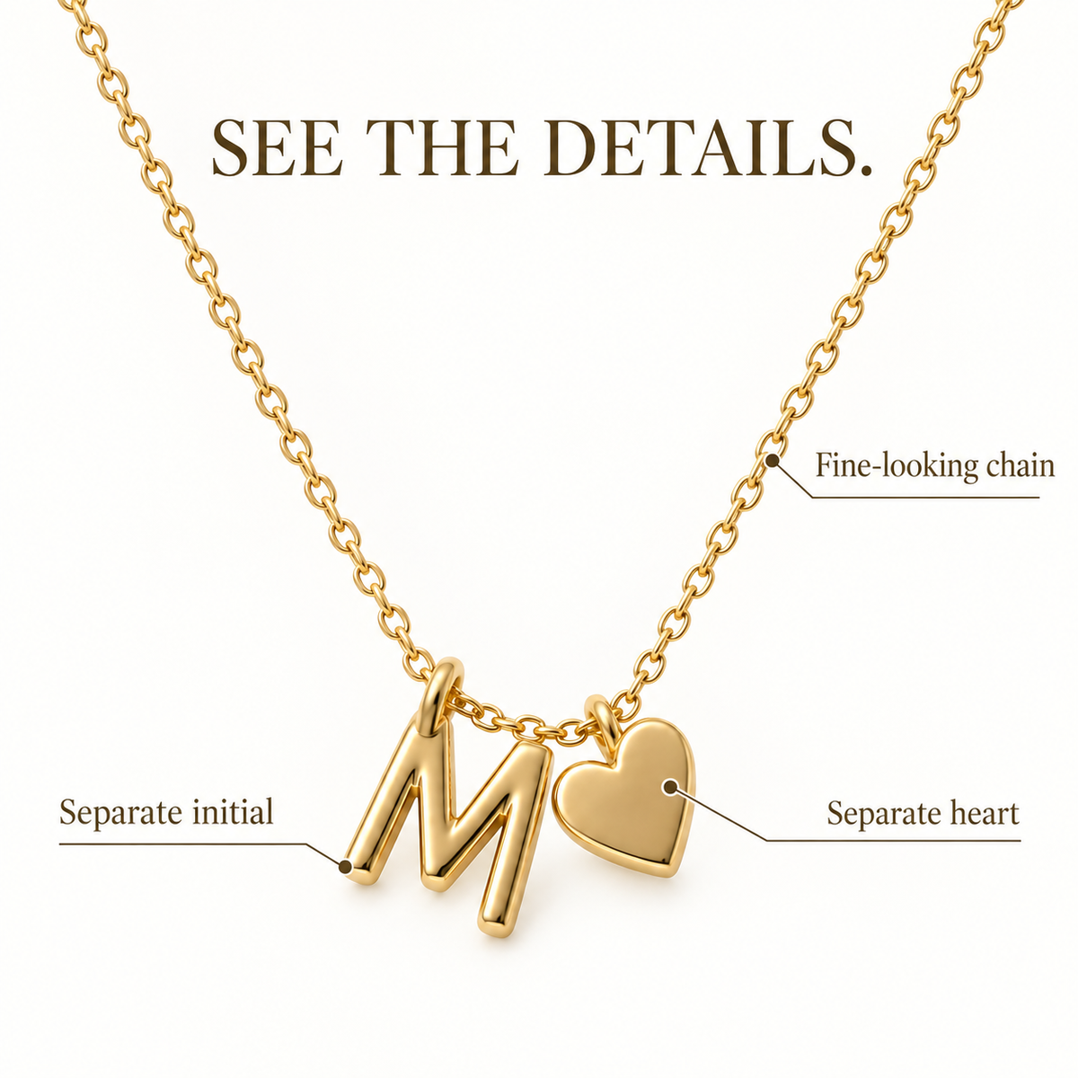Close-up of a heart charm, letter charm, and necklace chain