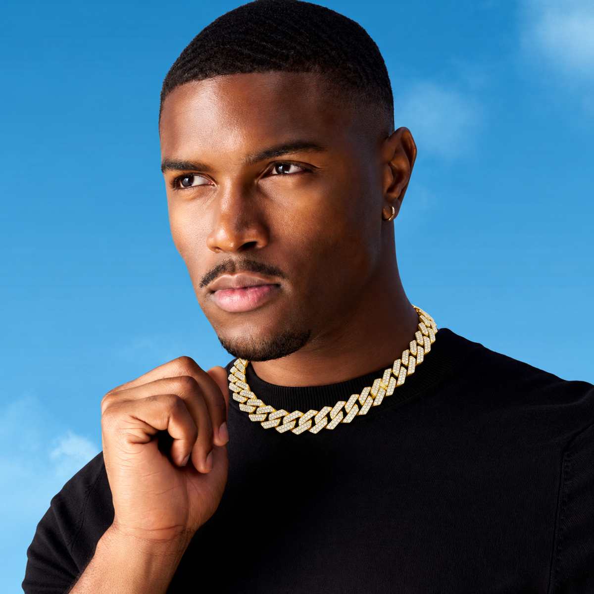 Gold-tone Cuban link chain styling visualization against blue backdrop