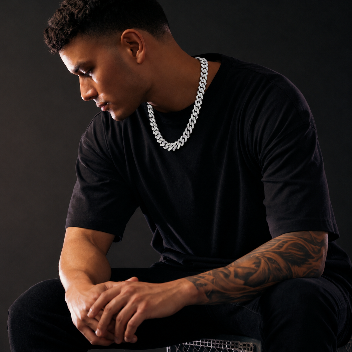 Silver-tone Cuban link chain styling visualization in dark studio