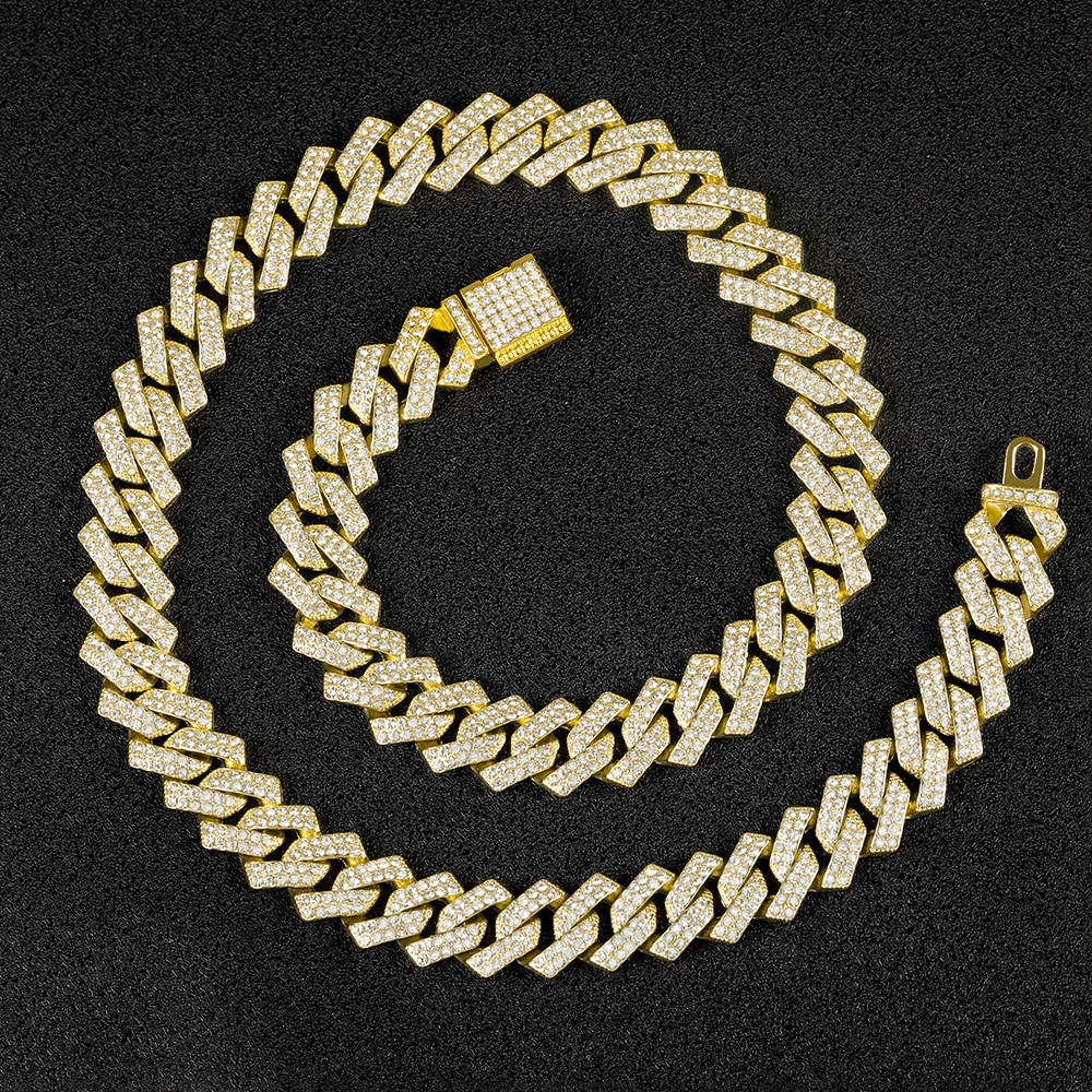 Gold-tone Cuban link chain on black background