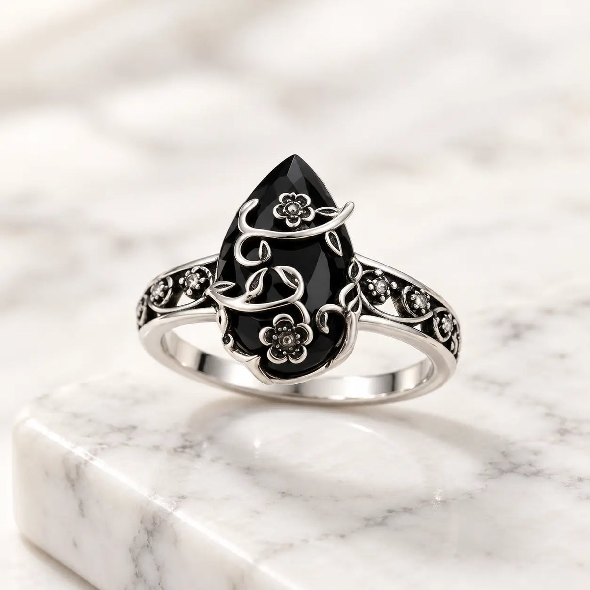 Exact front product view of the black teardrop flower ring