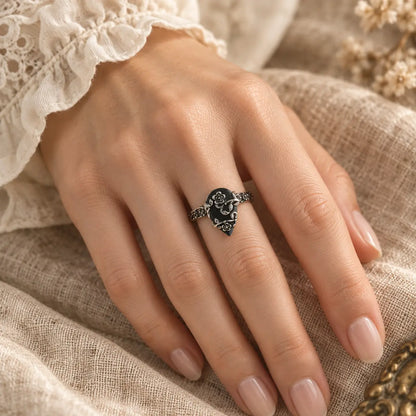 Second exact on-hand view of the black teardrop flower ring