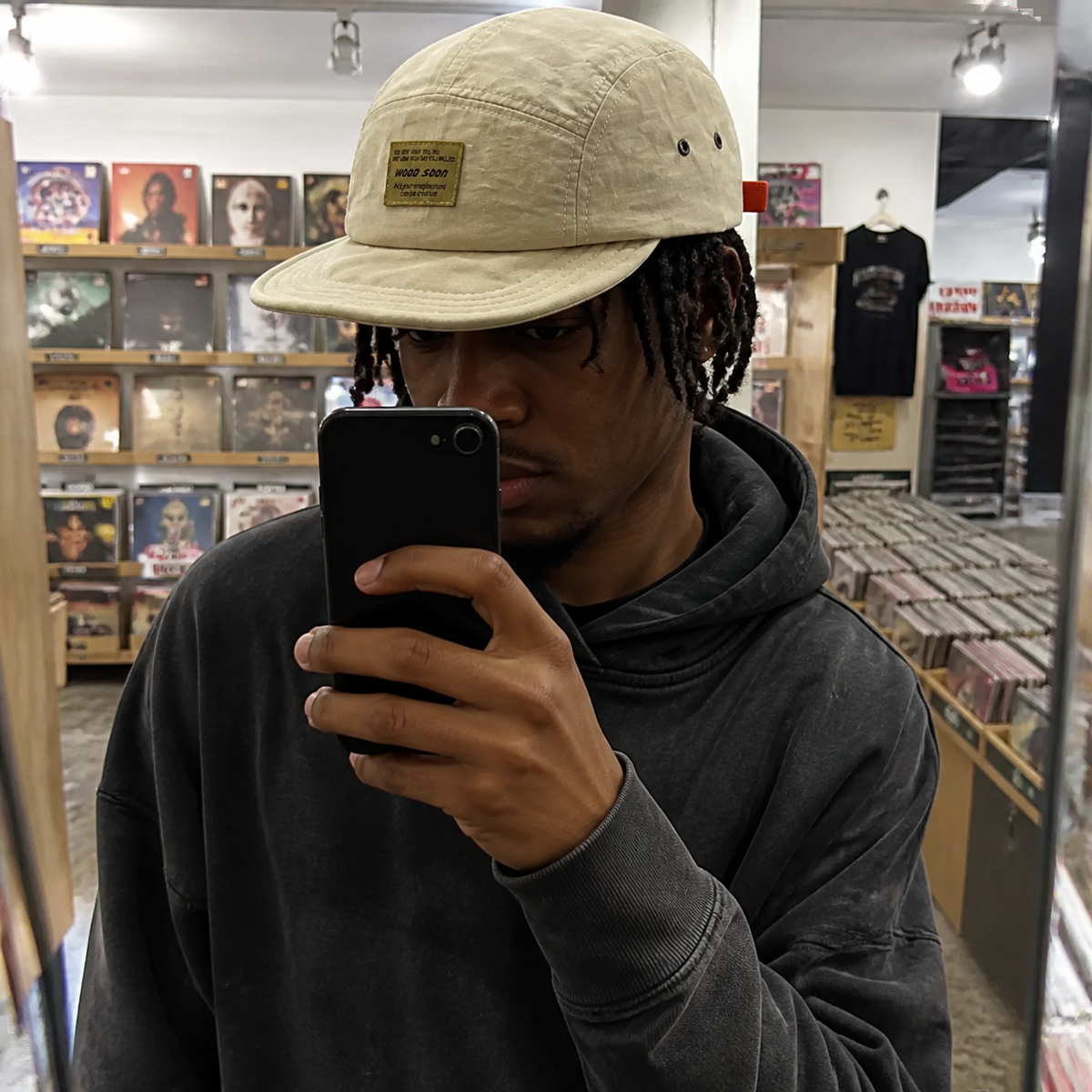 Man wearing the lightweight cap in a record shop