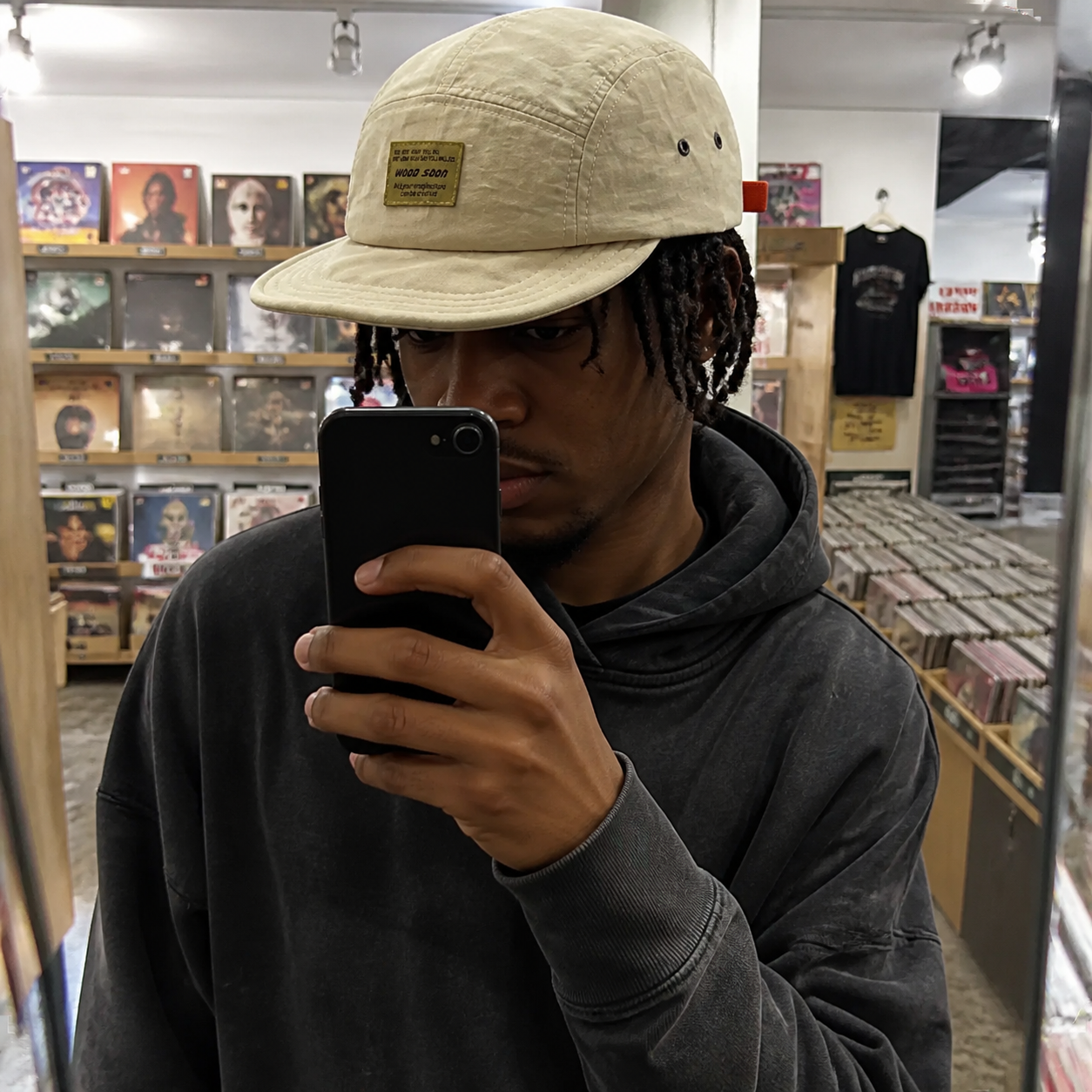 Man wearing the lightweight cap in a record shop