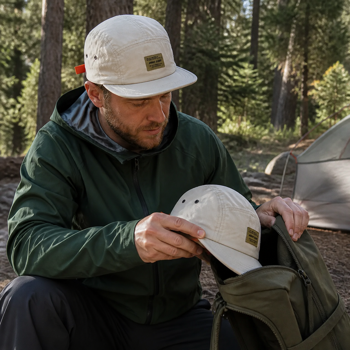 Camper packing the flexible cap into a backpack