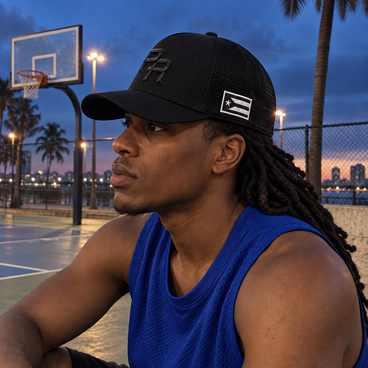 Customer wearing the Black Mesh Puerto Rico PR cap beside a basketball court