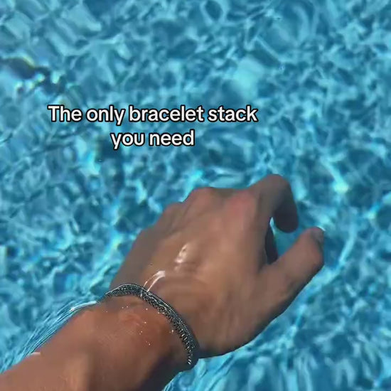 Veyron silver-tone bracelet stack shown beside a bright blue pool