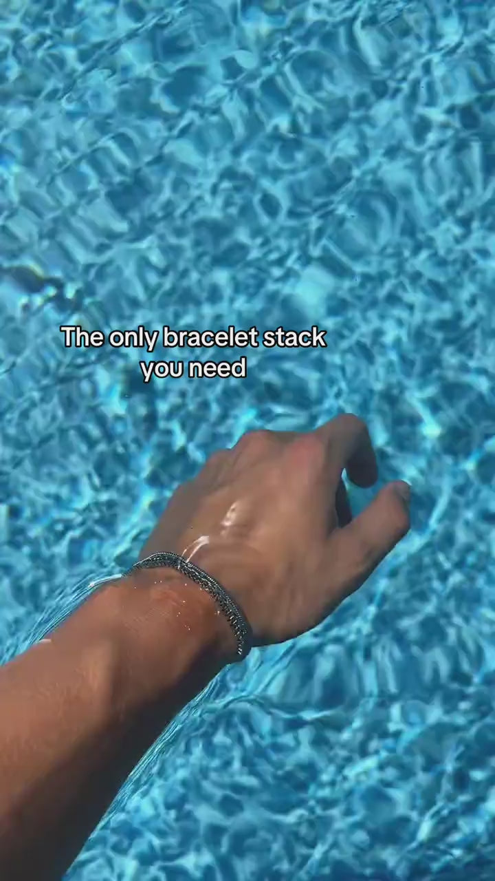 Veyron silver-tone bracelet stack shown beside a bright blue pool