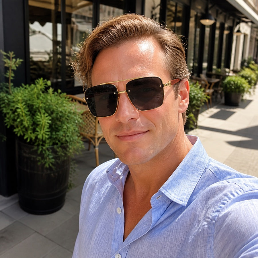 Original Riviera styling model wearing Midnight Black sunglasses outside a city cafe